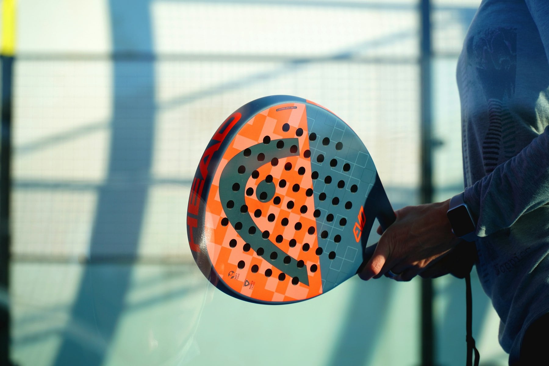 A padel racket on court